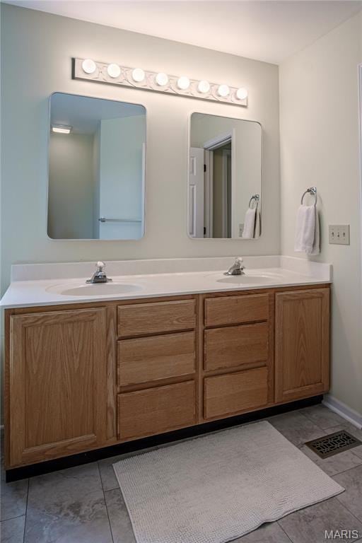 full bath with double vanity and tile patterned floors