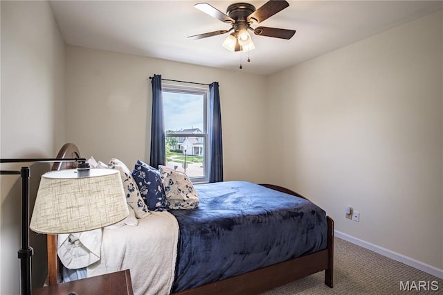 bedroom featuring carpet floors, baseboards, and a ceiling fan
