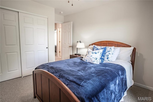 bedroom featuring carpet floors, a closet, and baseboards