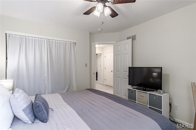 bedroom with a ceiling fan and baseboards