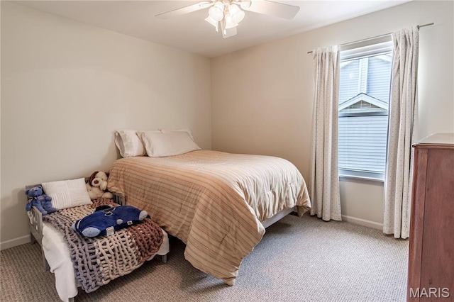 carpeted bedroom featuring baseboards and ceiling fan