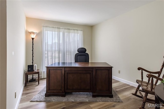 home office featuring light wood-type flooring and baseboards