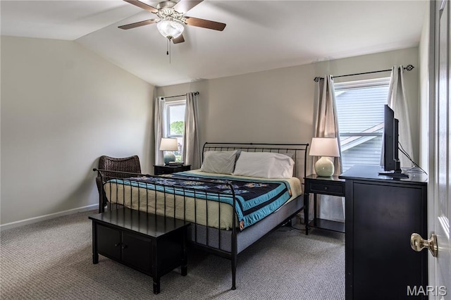 bedroom with carpet floors, lofted ceiling, baseboards, and a ceiling fan
