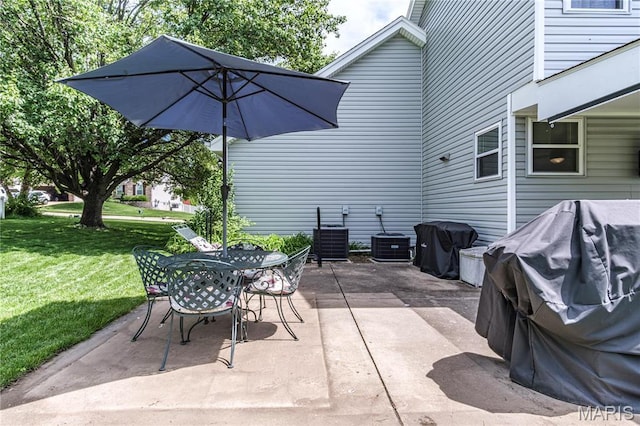 view of patio with outdoor dining space, cooling unit, and area for grilling