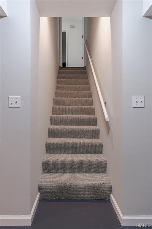 stairway featuring baseboards