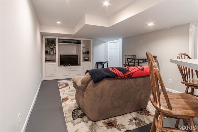 living room featuring baseboards and recessed lighting