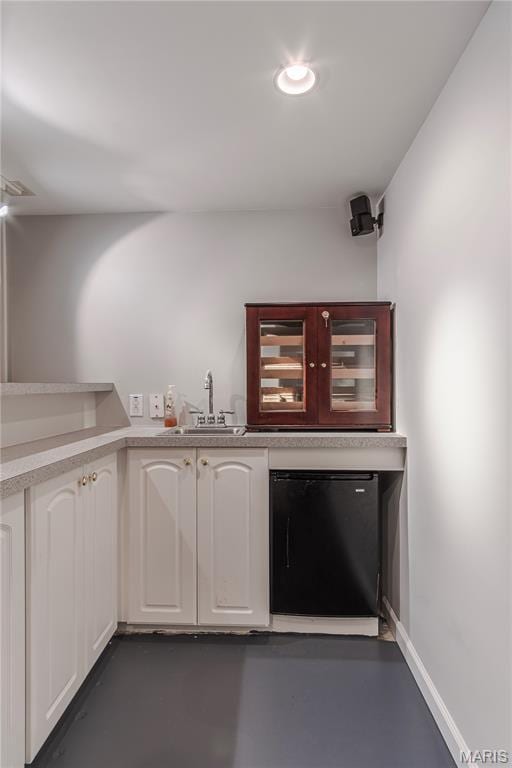bar with a sink, refrigerator, and recessed lighting