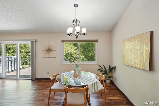 13112 Royal Pines Dr, Saint Louis, MO 63146 - dining area featuring wood finished floors, a chandelier, baseboards, and a textured ceiling