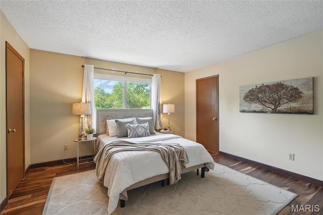 13112 Royal Pines Dr, Saint Louis, MO 63146 - bedroom with baseboards, a textured ceiling, and wood finished floors