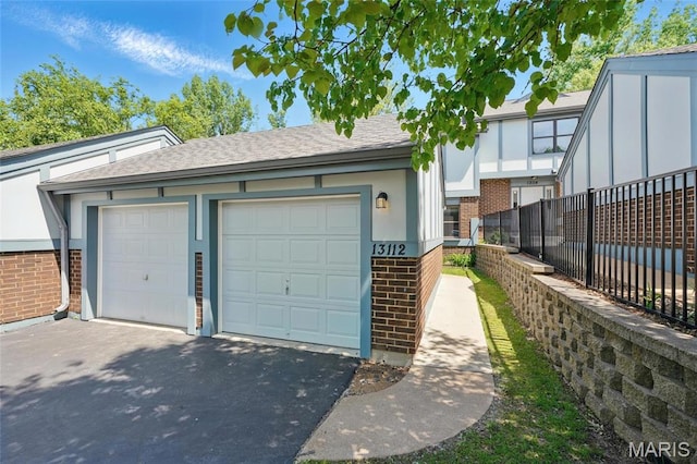 13112 Royal Pines Dr, Saint Louis, MO 63146 - garage with fence and asphalt driveway