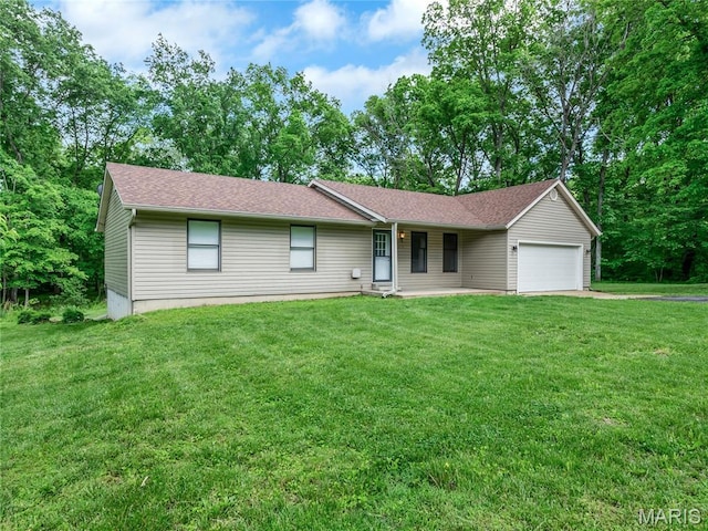 ranch-style house featuring an attached garage, a front yard, and driveway