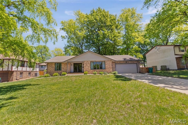 1012 Matthew Dr, Ofallon, IL 62269 - view of front of property featuring an attached garage, concrete driveway, brick siding, and cooling unit