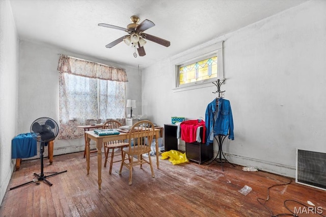 dining room with hardwood / wood-style flooring and a ceiling fan
