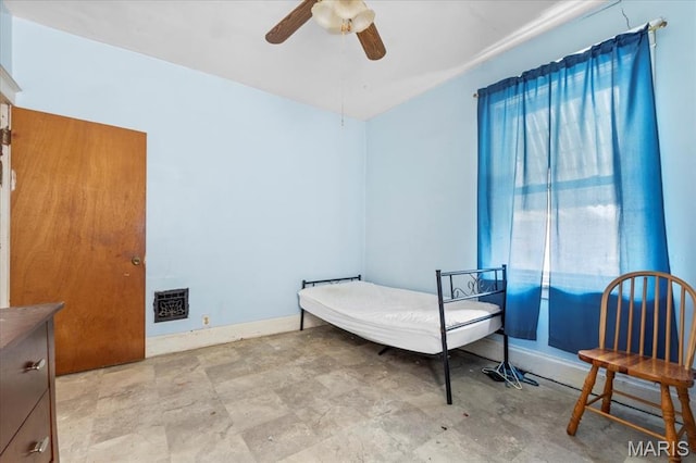 bedroom with a ceiling fan and baseboards