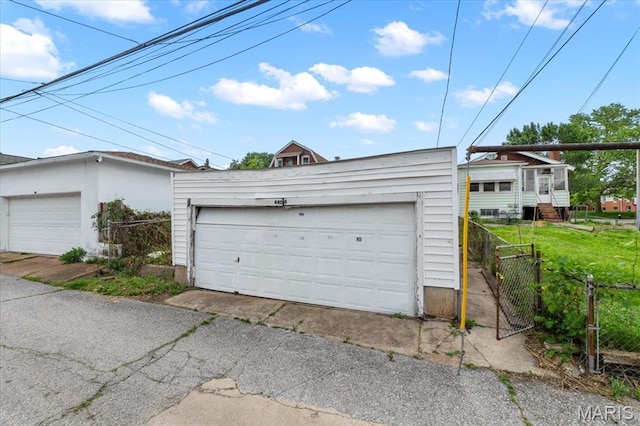 detached garage featuring fence