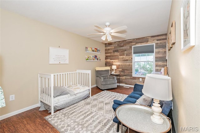 1408 Glacier Pass, Festus, MO 63028 - bedroom featuring wooden walls, baseboards, wood finished floors, an accent wall, and ceiling fan