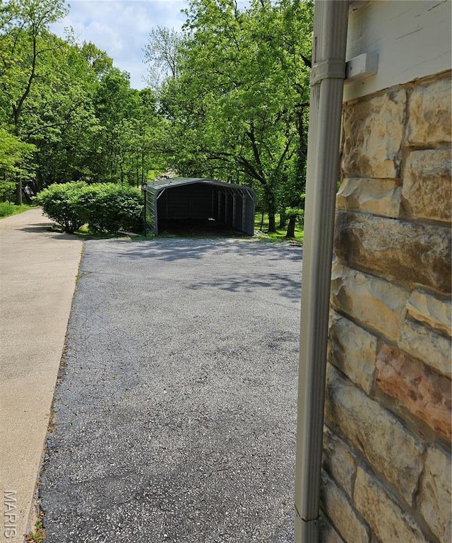 exterior view of stone siding and asphalt driveway