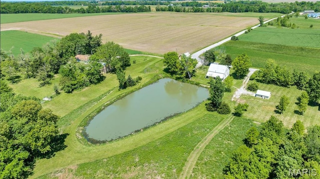 view of property location with rural landscape, abundant farmland, and a nearby body of water