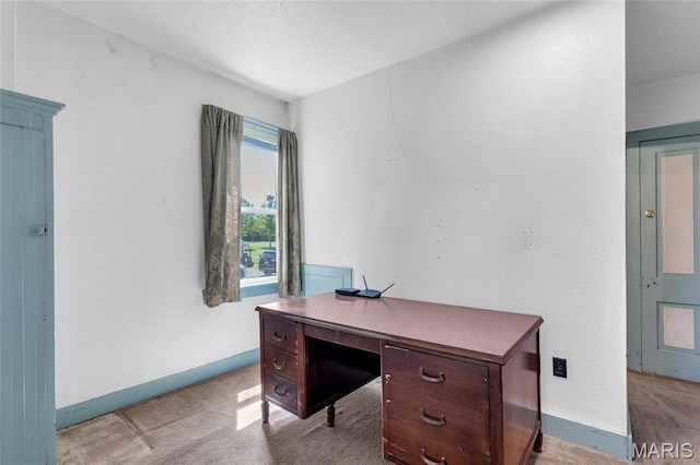 office with light colored carpet and baseboards