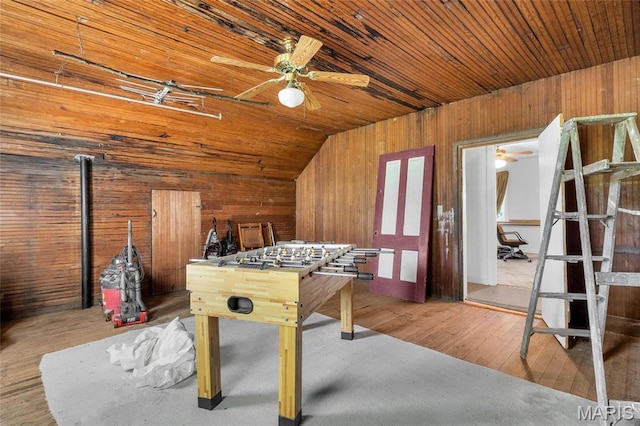 playroom with wooden walls, ceiling fan, lofted ceiling, wooden ceiling, and wood finished floors