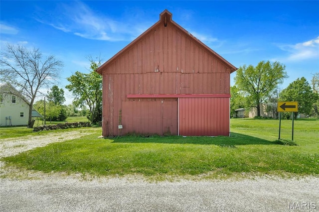 view of barn with a lawn