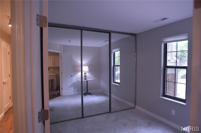 unfurnished bedroom featuring carpet floors and baseboards