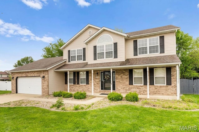 traditional-style house with brick siding, covered porch, and an attached garage