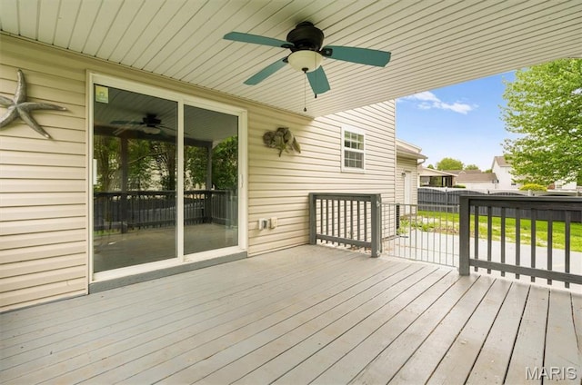 wooden terrace with a ceiling fan and fence