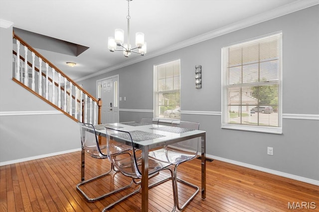 dining space with stairway, wood-type flooring, a chandelier, crown molding, and baseboards