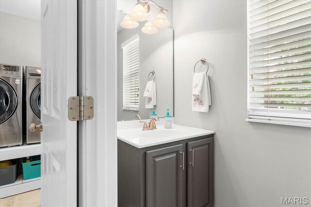 bathroom featuring washing machine and dryer and vanity