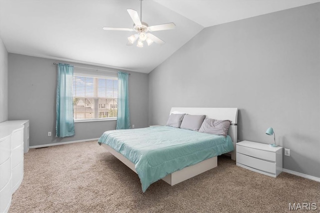 bedroom featuring carpet floors, lofted ceiling, a ceiling fan, and baseboards