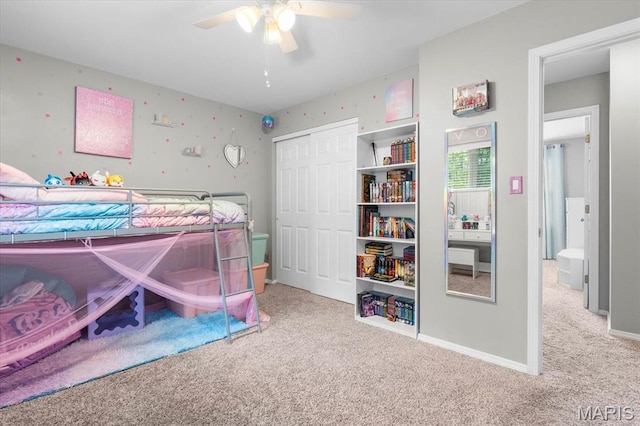 bedroom with carpet flooring, a closet, a ceiling fan, and baseboards