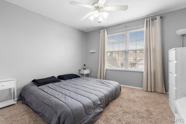 carpeted bedroom featuring ceiling fan and baseboards
