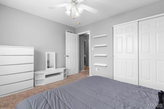 bedroom with carpet, a closet, and ceiling fan