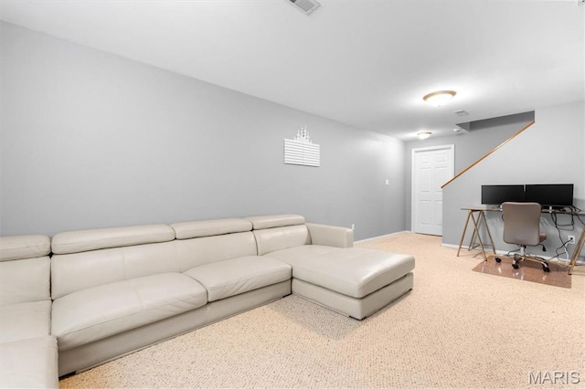 carpeted living room with a desk