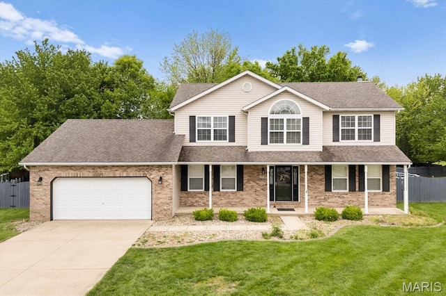 traditional-style house with a garage, brick siding, covered porch, and driveway
