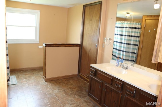 206 E Spring St, Doniphan, MO 63935 - bathroom with double vanity, a shower with shower curtain, and stone finish floors