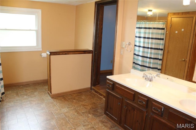 206 E Spring St, Doniphan, MO 63935 - bathroom with double vanity, curtained shower, and stone finish floors