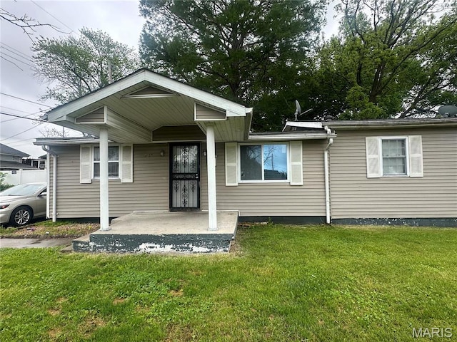 514 N 48th St E, St Louis, IL 62205 - view of front of home featuring a front lawn and covered porch