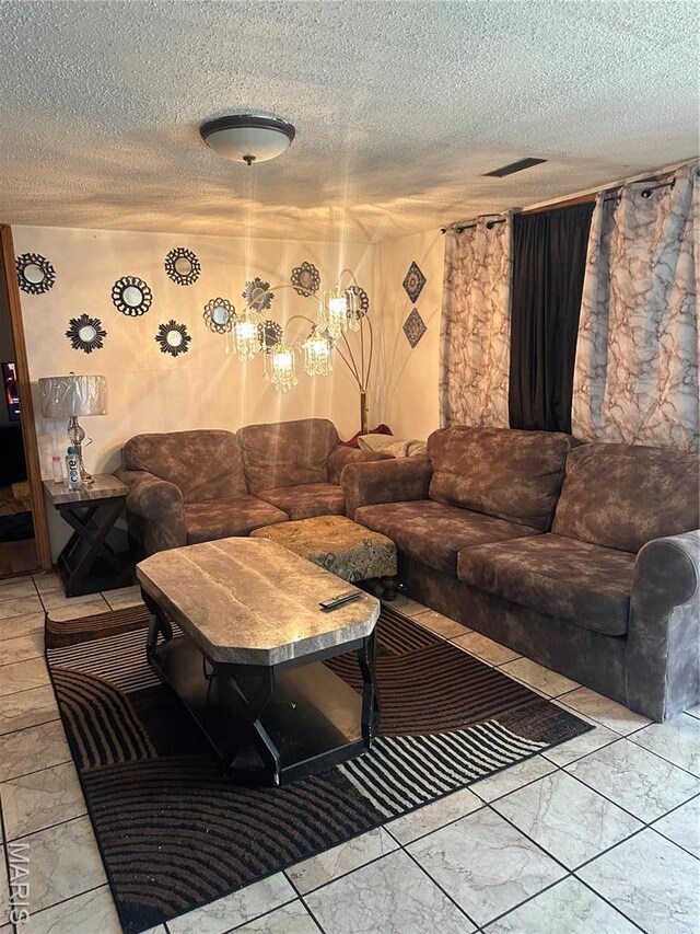 514 N 48th St E, St Louis, IL 62205 - living area featuring a textured ceiling, marble finish flooring, and a chandelier