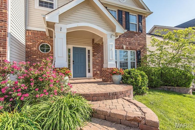 346 Palisades Ridge Ct, Eureka, MO 63025 - view of exterior entry with brick siding and a yard