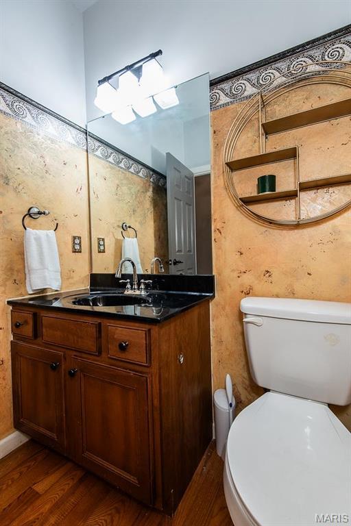 346 Palisades Ridge Ct, Eureka, MO 63025 - half bathroom with wood finished floors, toilet, and vanity