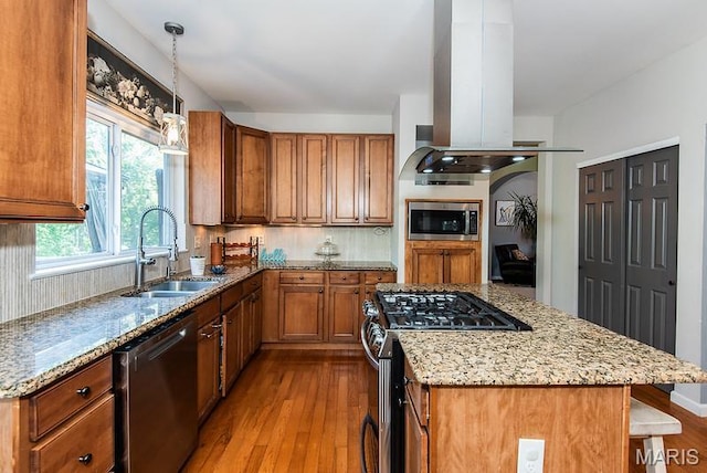 346 Palisades Ridge Ct, Eureka, MO 63025 - kitchen featuring appliances with stainless steel finishes, a sink, wood finished floors, brown cabinets, and light stone countertops