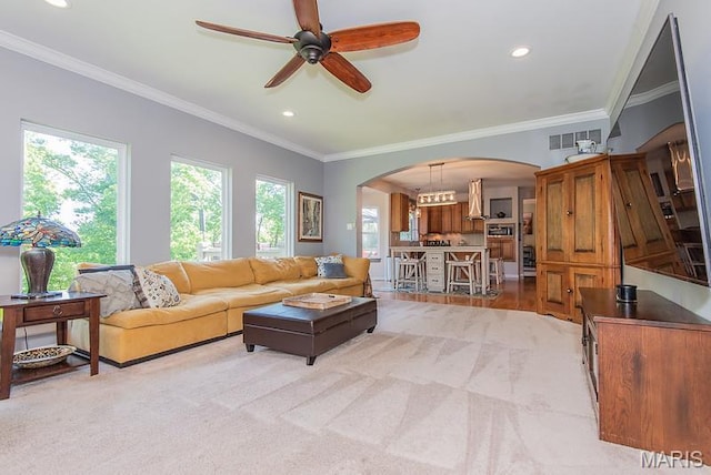 346 Palisades Ridge Ct, Eureka, MO 63025 - living room featuring arched walkways, healthy amount of natural light, a ceiling fan, recessed lighting, and crown molding