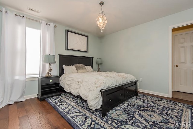 346 Palisades Ridge Ct, Eureka, MO 63025 - bedroom with baseboards, dark wood-type flooring, and a chandelier