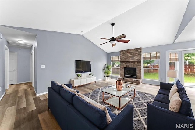 1102 Danielle Elizabeth Ct, Ofallon, MO 63366 - living room featuring lofted ceiling, a ceiling fan, plenty of natural light, wood finished floors, and a fireplace