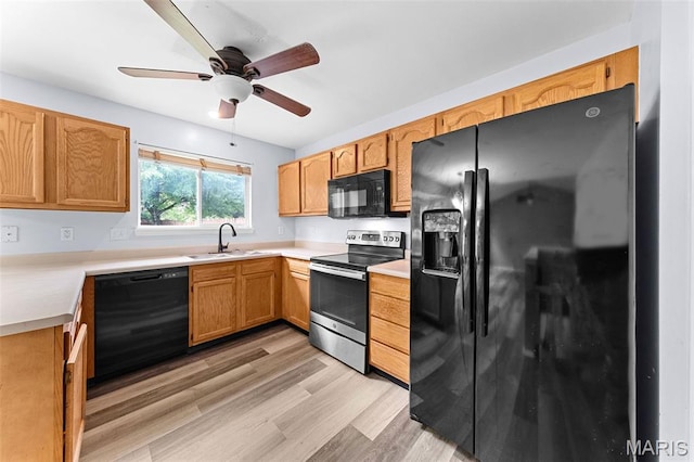 1102 Danielle Elizabeth Ct, Ofallon, MO 63366 - kitchen with black appliances, light wood-type flooring, light countertops, and ceiling fan