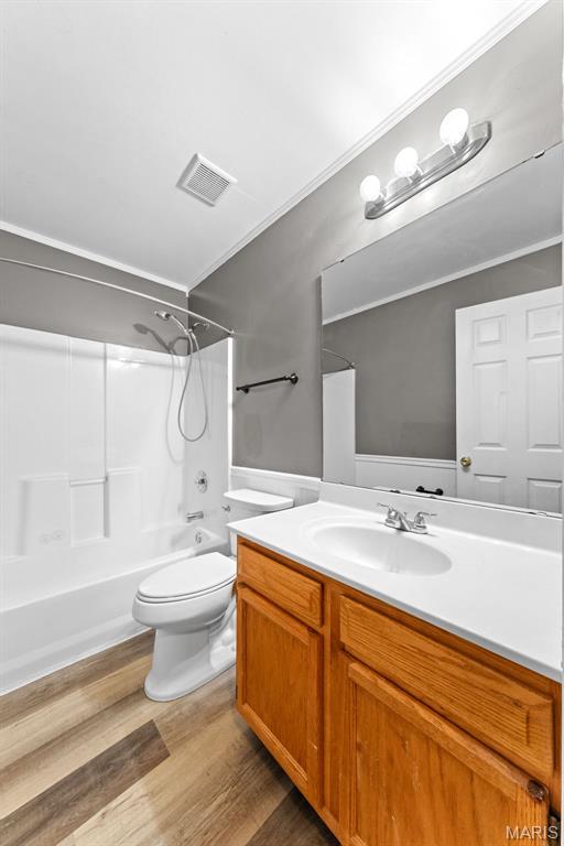 1102 Danielle Elizabeth Ct, Ofallon, MO 63366 - bathroom featuring vanity, bathing tub / shower combination, and wood finished floors