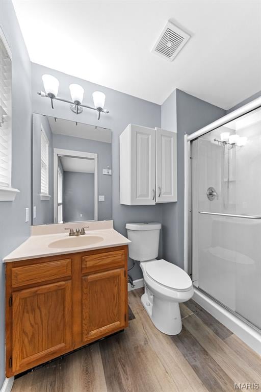 1102 Danielle Elizabeth Ct, Ofallon, MO 63366 - full bath with wood finished floors, vanity, and a shower stall