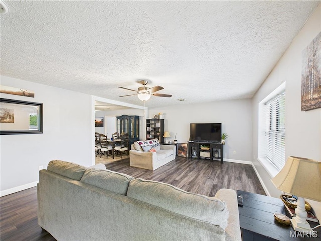 14469 Tailor Rd, Saint Robert, MO 65584 - living room featuring wood finished floors, a ceiling fan, a textured ceiling, and baseboards